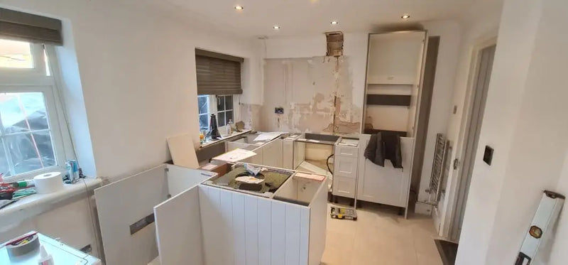 Kitchen carcasses being fitted during a full strip-out and first fix renovation in a London home by ODS Plumbing & Construction