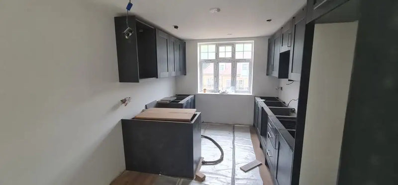 Navy shaker U-shaped kitchen with central island being fitted in a London home by ODS Plumbing & Construction