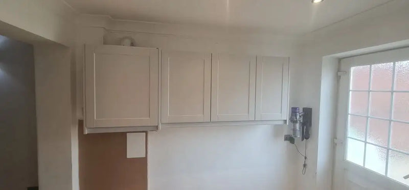 White shaker-style kitchen wall units fitted in a London home during renovation by ODS Plumbing & Construction
