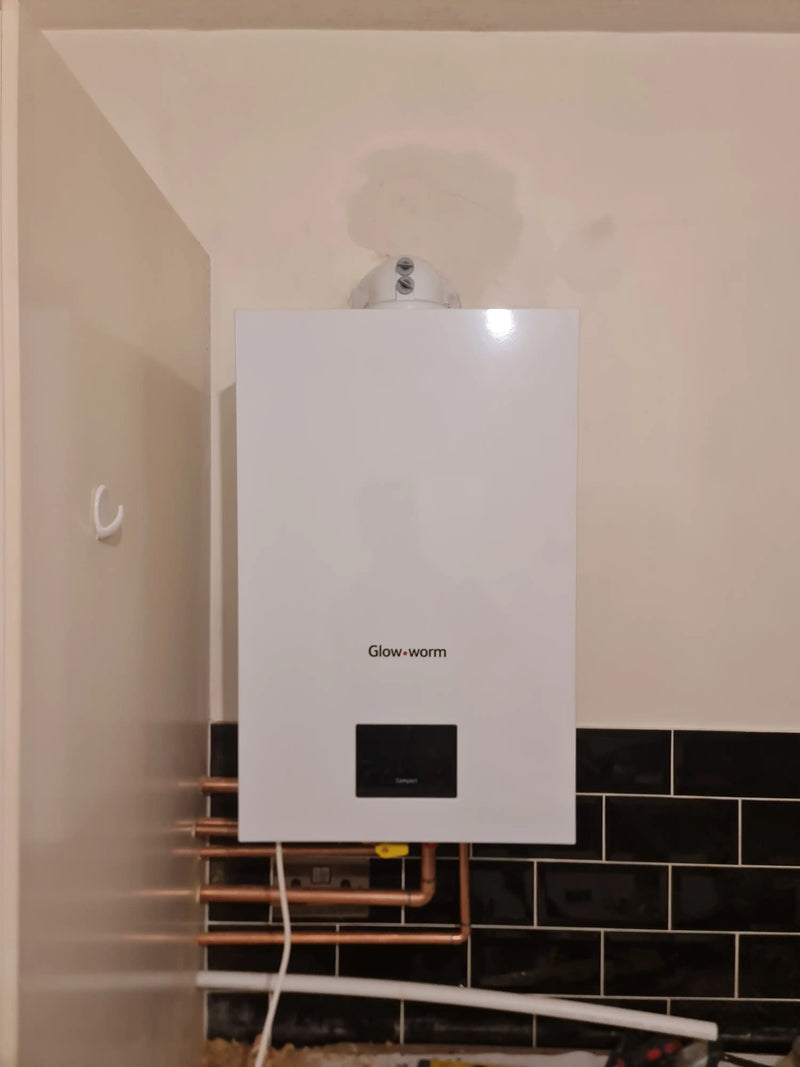 New Glow-worm Energy Compact boiler installation with horizontal copper pipework in London by ODS Plumbing & Construction.