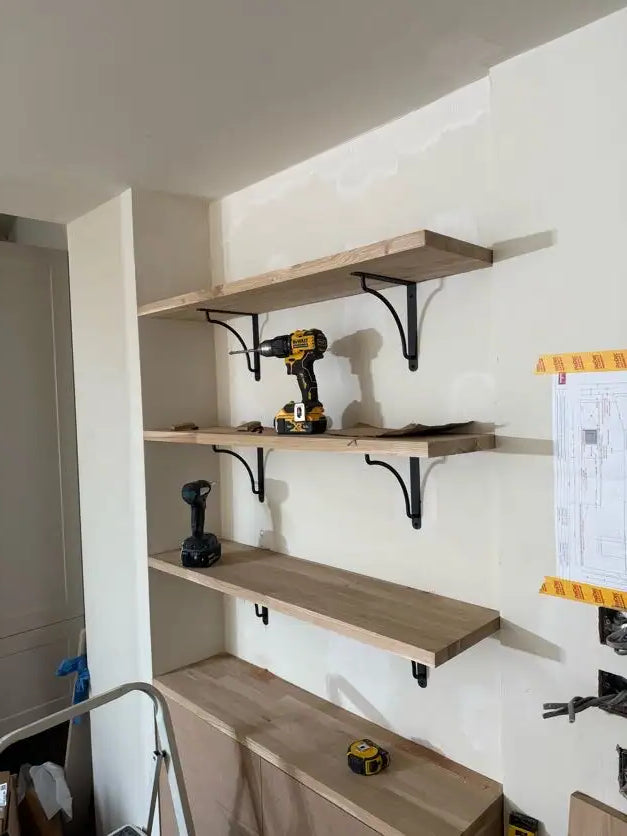 Kitchen base unit carcasses being assembled with brackets and power tools during a London renovation by ODS Plumbing & Construction