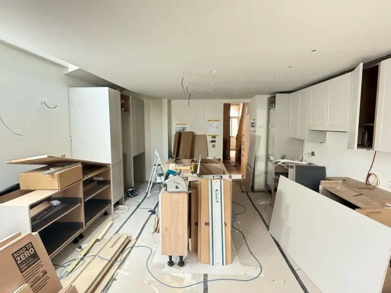 Large kitchen renovation in progress with carcasses, worktops and Howdens units being assembled in a London property by ODS Plumbing & Construction