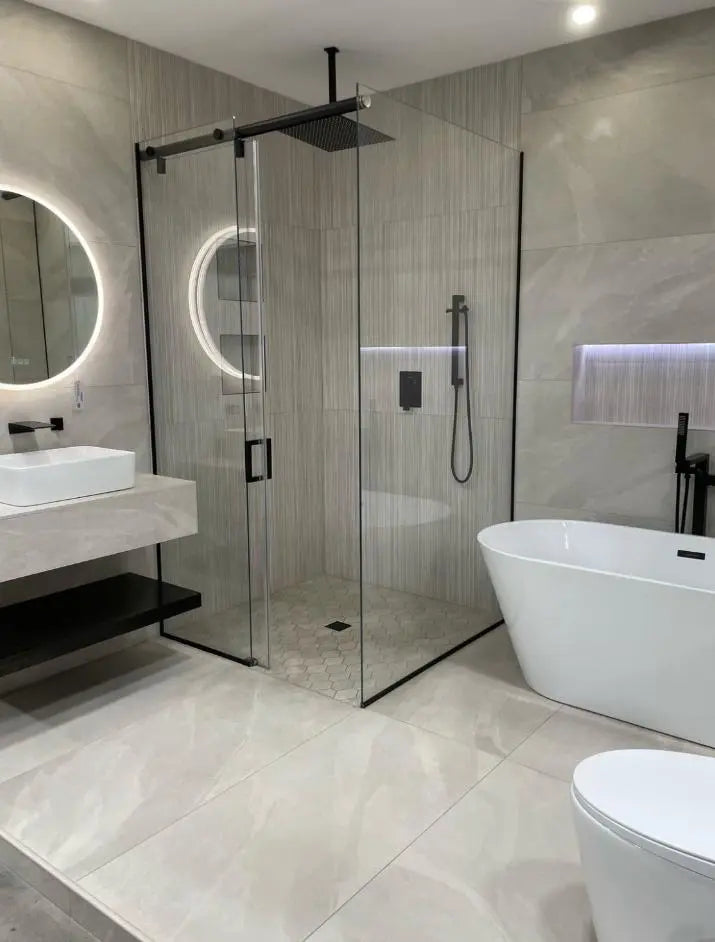Luxury bathroom featuring a ceiling-mounted rainfall shower, freestanding bathtub, and floating stone vanity installed by ODS Plumbing & Construction in London.