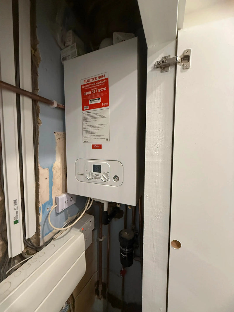 Main Eco Compact Combi boiler installed in a small cupboard with Adey magnetic filter by ODS Plumbing & Construction London.