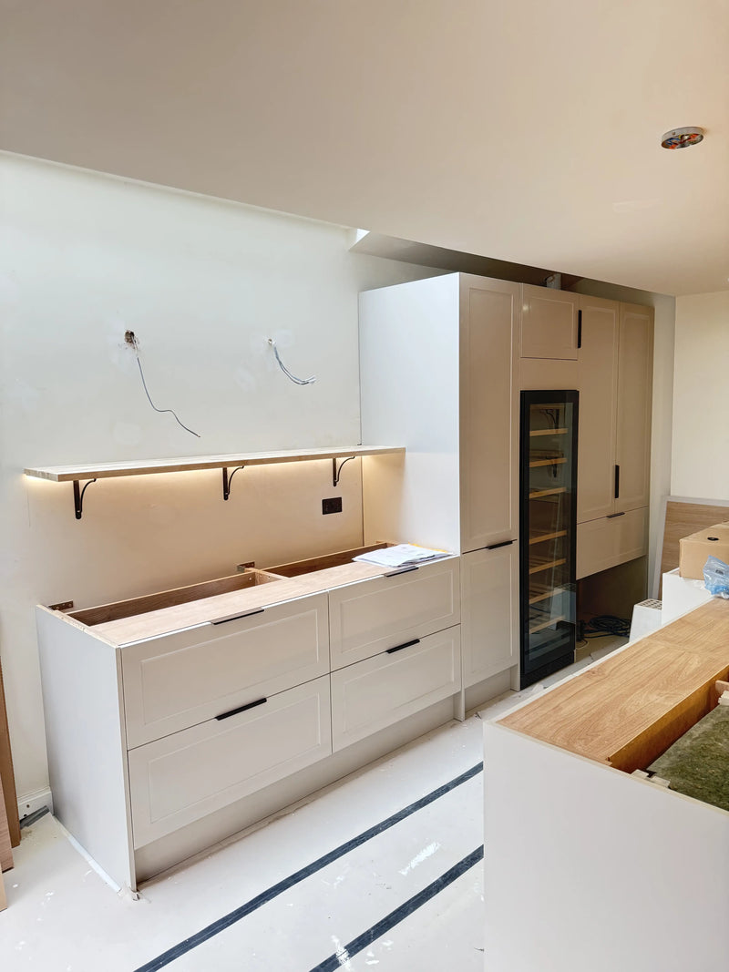 Modern kitchen installation in London with fitted cabinetry, under-cabinet lighting, and plumbing preparation by ODS Plumbing & Construction